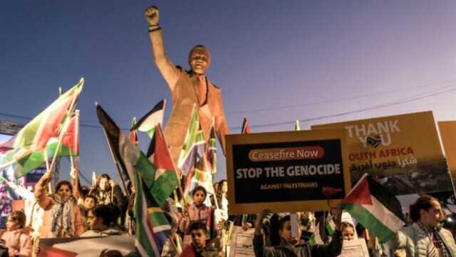 فلسطينيون يتظاهرون أمام تمثال نيلسون مانديلا في رام الله